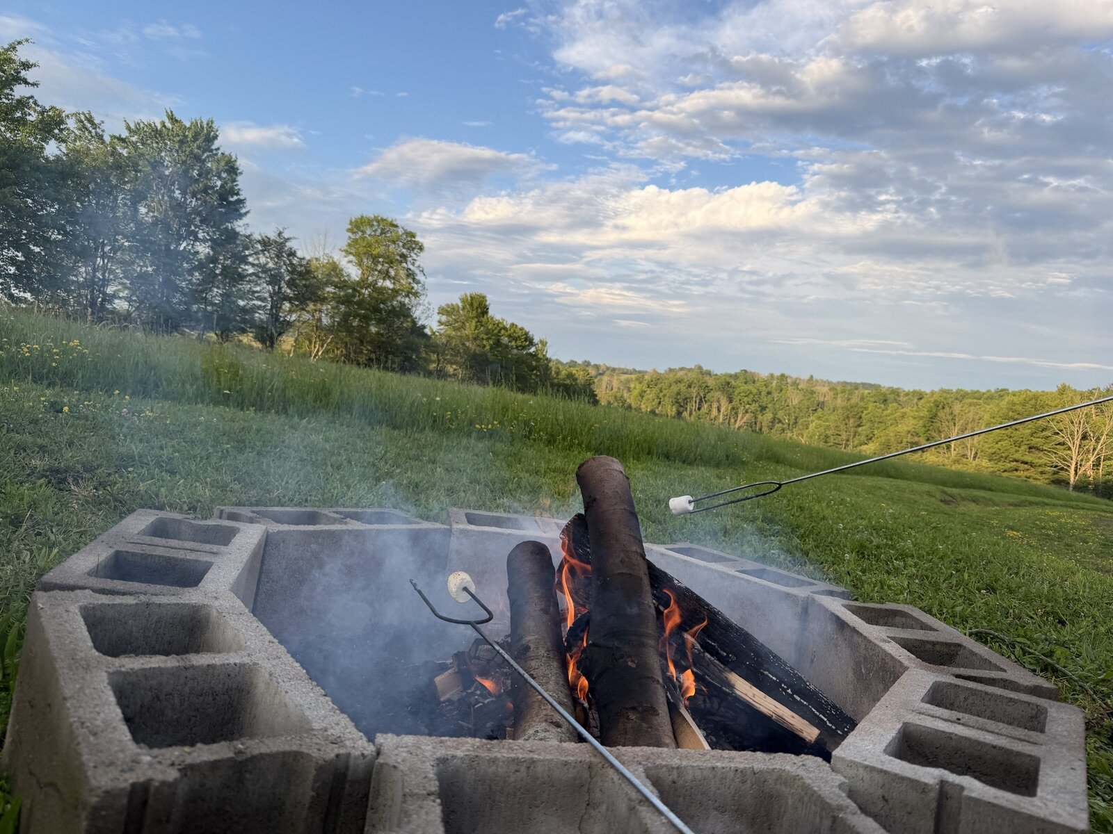 Roasting marshmallows over the fire pit at golden hour