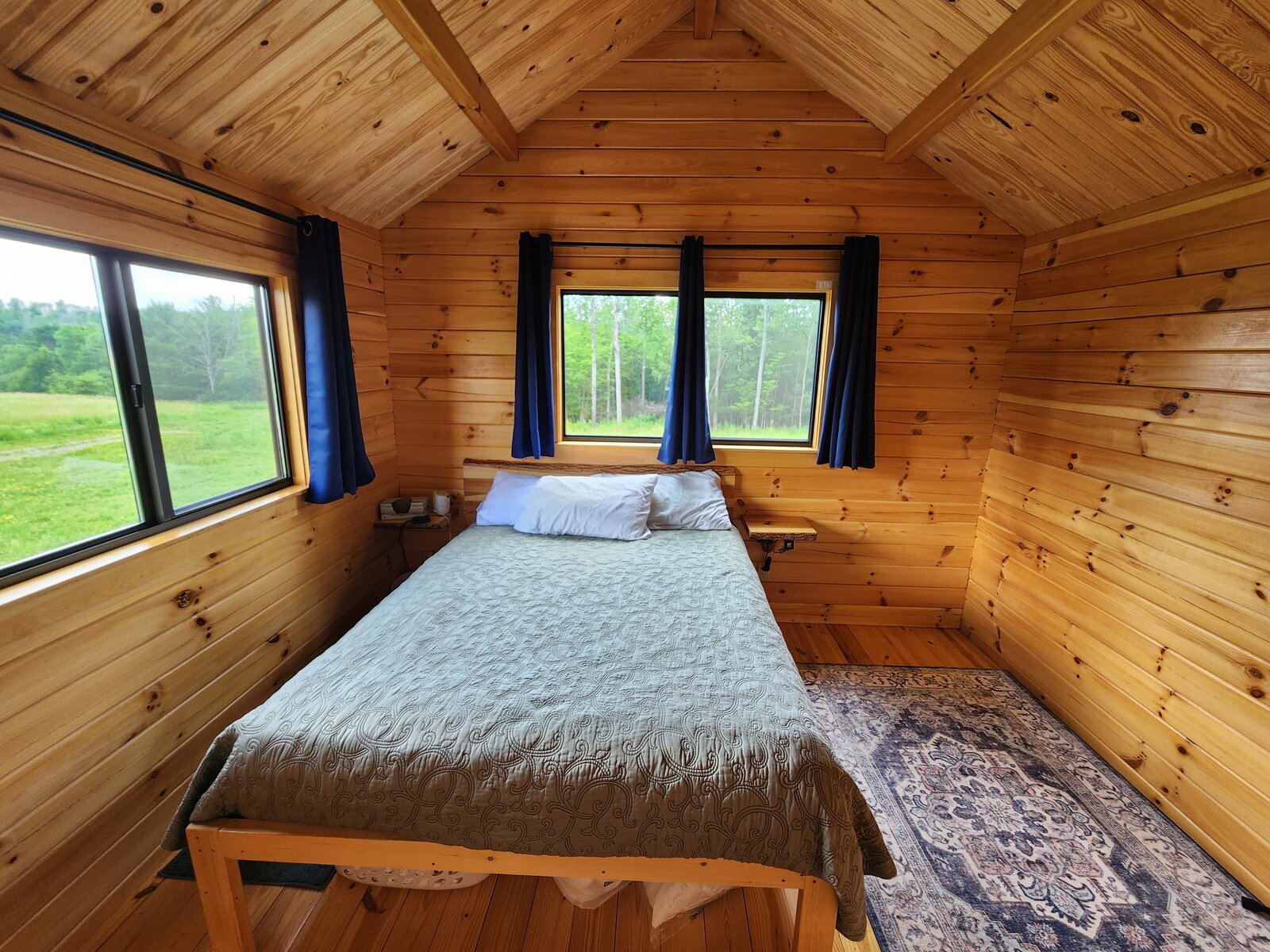 The bedroom with windows on the meadow