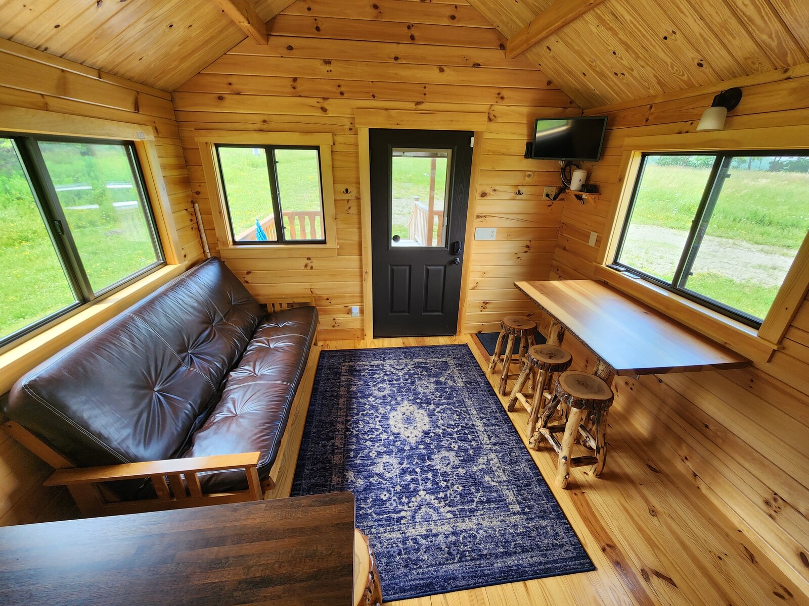 The living room with a leather futon and breakfast bar