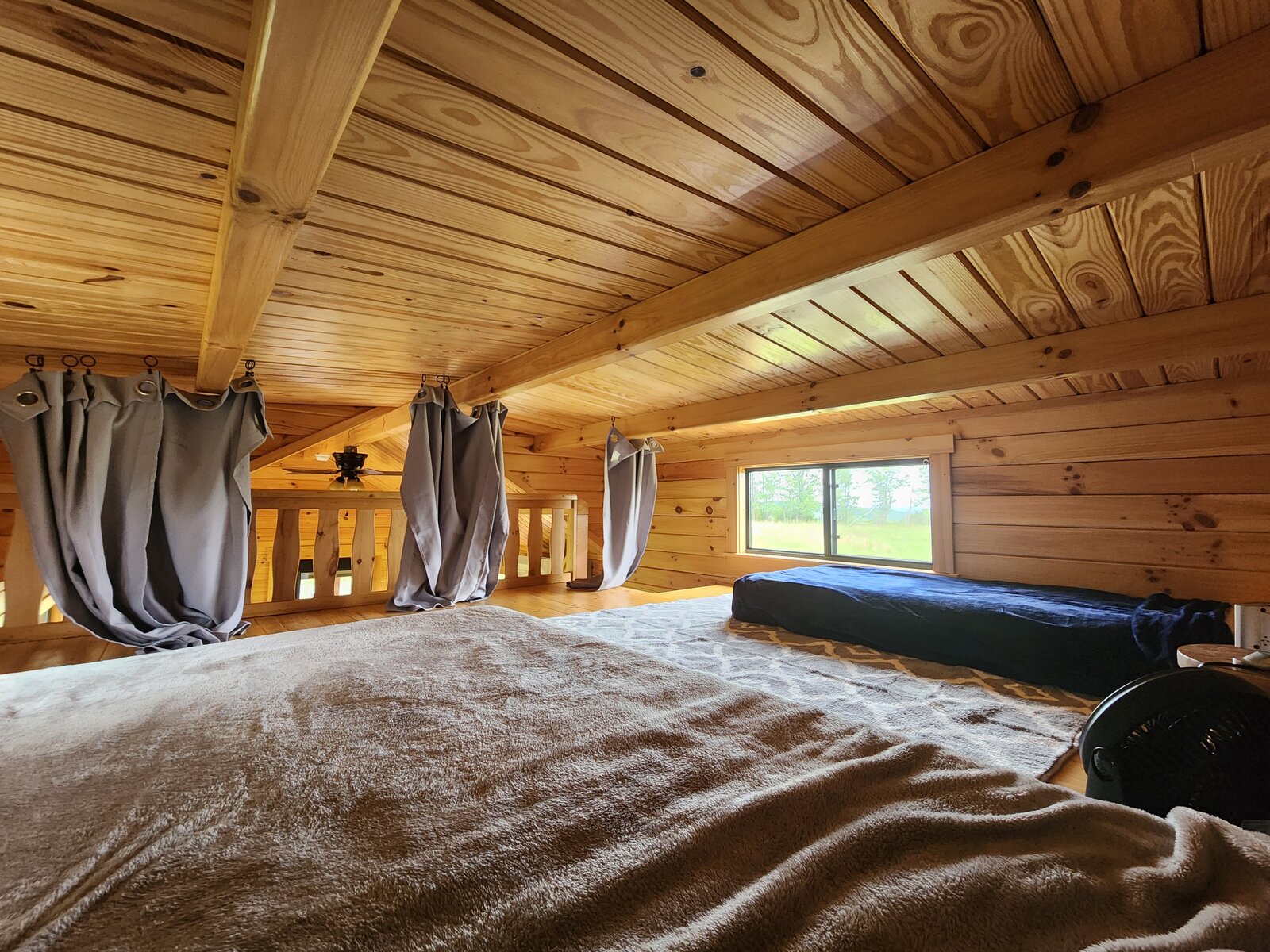 The sleeping loft with a futon and its own meadow view