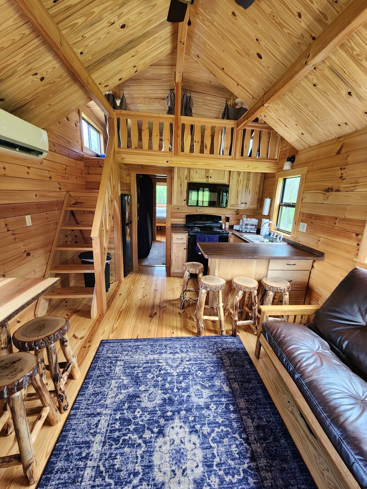 The main room, looking toward the kitchen and sleeping loft
